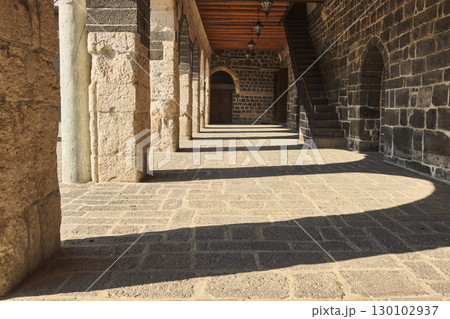 Stone corridor with arches and deep shadows Stone corridor with arches and deep shadows 130102937