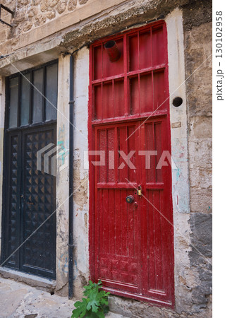 Old Red Wooden Door in Historic Stone Wall Old Red Wooden Door in Historic Stone Wall 130102958