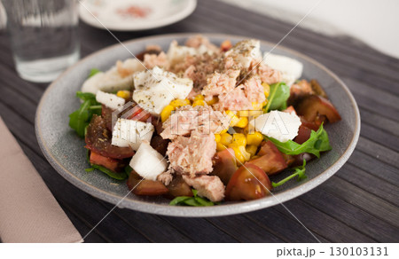 Plate of salad with tuna, corn, tomatoes and arugula Plate of salad with tuna, corn, tomatoes and arugula 130103131