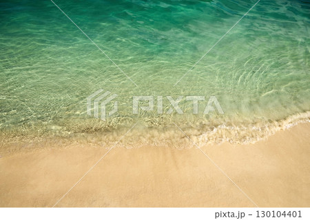 Serene Beach Shoreline. Clear turquoise water gently laps against a sandy beach. Serene Beach Shoreline. Clear turquoise water gently laps against a sandy beach. 130104401