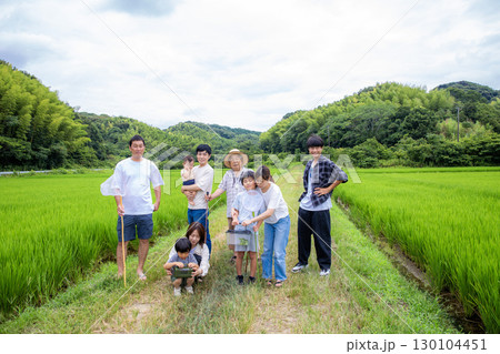 夏休み帰省した故郷でみんなで遊ぶ　家族仲間の集合写真 130104451