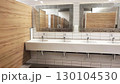 Modern restroom with stylish fixtures and wooden accents in a public building 130104530