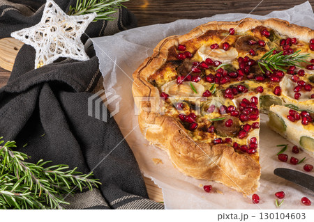 Homemade quiche with vegetables, brussels spouts, goat cheese and pomegranate. Vegetarian food. French cuisine Homemade quiche with vegetables, brussels spouts, goat cheese and pomegranate. Vegetarian food. French cuisine 130104603