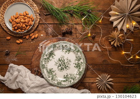 Almonds nuts on a plate placed on a rustic wooden board. Delicious sweet almonds on the wooden table, roasted almond nut for healthy food and snack 130104623