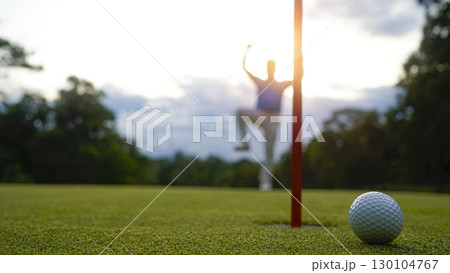 Golfers are putting golf in the evening golf course golf backglound. Golfer hitting golf ball. 130104767