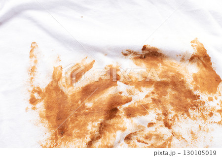 Dirty stains covering white t-shirt lying on wooden table Dirty stains covering white t-shirt lying on wooden table 130105019