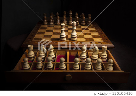 Chess pieces of wood on a beautiful chessboard. A puzzle game with tricky combinations that requires planning and thinking. 130106410