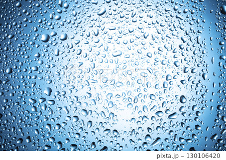 Water drops on glass on a blue background. 130106420