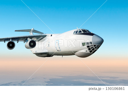 White wide body transport freight airliner fly in the air above the clouds 130106861