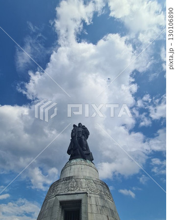 Berlin, Germany - August 1, 2025: Soviet War Memorial, Treptower Park, bronze statue of a Soviet soldier with a sword holding a German child, standing over a broken swastika 130106890