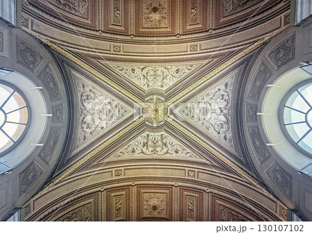 A stunning view of an ornately decorated ceiling, featuring a grand, symmetrical design. Intricate carvings, gold accents, and detailed reliefs inside Pio-Clementino Museum 130107102