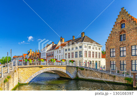 Bruges cityscape, Sint-Annareibrug stone Bridge, Sint Annarei water canal of Reie river, medieval buildings in Bruges city historic centre, embankment in Brugge old town, Flemish Region, Belgium 130108397