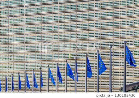 Berlaymont building wall and European Union EU flags, modernism architecture style, modern high-rise office building, abstract details of facade wall, patterned cells, Brussels city, Belgium Berlaymont building wall and European Union EU flags, modernism architecture style, modern high-rise office building, abstract details of facade wall, patterned cells, Brussels city, Belgium 130108430