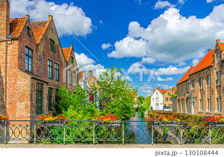 Ezelbrug Donkey Bridge across Augustijnenrei Augustine water canal, bridge with flowers on fence, green trees and old houses in Brugge old town, Bruges city historic centre, Flemish Region, Belgium Ezelbrug Donkey Bridge across Augustijnenrei Augustine water canal, bridge with flowers on fence, green trees and old houses in Brugge old town, Bruges city historic centre, Flemish Region, Belgium 130108444