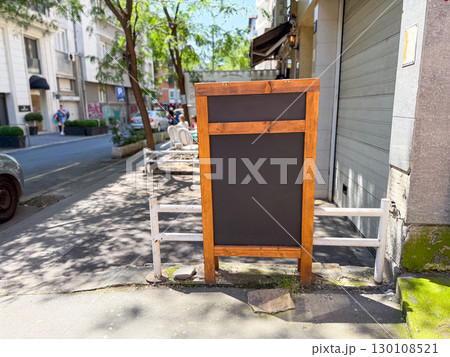 Wooden board on city street. Symbol of communication, urban environment, and information space. Copy space 130108521