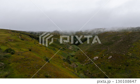 Low clouds covering green hills near Sintra, Portugal, creating a mysterious and atmospheric landscape 130108647