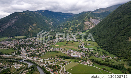 Aerial view of Sainte Marie de Cuines in the Maurienne valley, Savoie department, Auvergne Rhone Alpes region, France, showcasing the town nestled amidst mountains and lush greenery Aerial view of Sainte Marie de Cuines in the Maurienne valley, Savoie department, Auvergne Rhone Alpes region, France, showcasing the town nestled amidst mountains and lush greenery 130108711