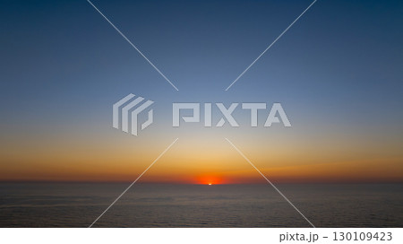 Colorful sunset over the vastness of the Atlantic ocean, creating a breathtaking view in Nazare, Portugal Colorful sunset over the vastness of the Atlantic ocean, creating a breathtaking view in Nazare, Portugal 130109423