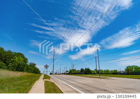 road way with power lines. travelling by road way. road way with no cars. empty road with destination in horizon. trip route road way with power lines. travelling by road way. road way with no cars. empty road with destination in horizon. trip route 130109445