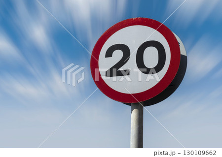 Twenty miles an hour speed limit against blue sky 130109662