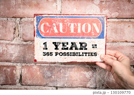 New Year Motivation Concept. 365 Possibilities Sign Held on Brick Wall Background New Year Motivation Concept. 365 Possibilities Sign Held on Brick Wall Background 130109770