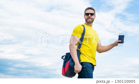 Man traveler holding travel bag and document sky background, copy space Man traveler holding travel bag and document sky background, copy space 130110005