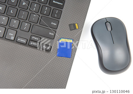sd memory card for recording electronic data near a laptop on a white background sd memory card for recording electronic data near a laptop on a white background 130110046