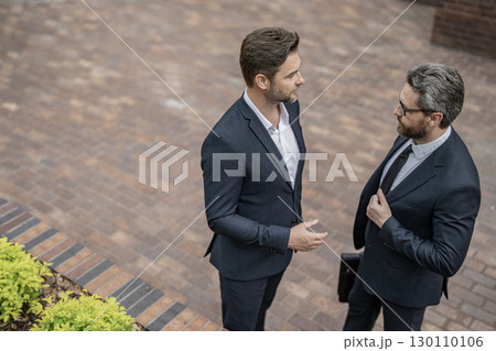 Business partner outdoor. Two businessmen in suit. Business conversation. Project partner talking. Successful businessmen. Copy space. Successful partnership communication. Business success 130110106