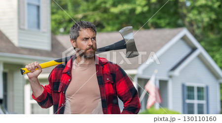 Lumberjack at his house with ax. Lumberjack sweating hold heavy axe. Strong man work in neighborhood. Lumberjack men with axe. Lumberjack carries axe. Handsome man with axe, copy space 130110160
