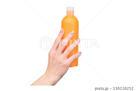 female hands hold lotion bottle with copy space 130110252