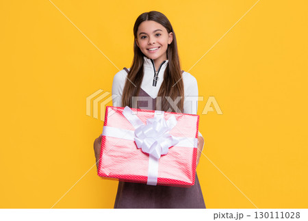 glad kid with present box on yellow background 130111028