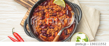 Mexican dish chili con carne with minced meat, red beans, lime, and spices top view Mexican dish chili con carne with minced meat, red beans, lime, and spices top view 130111552