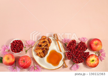 Jewish holiday Rosh Hashanah concept with apples, honey, pomegranate, challah bread and flowers for greeting card, creative layout and template for Jewish New Year and Thanksgiving, autumn banner 130112363