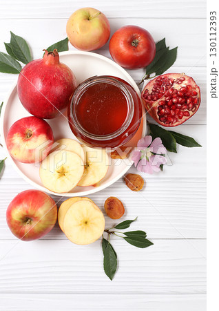 Apples, honey,pomegranate and dried apricots on a bright white wooden background,The concept of the Jewish holiday Rosh Hashanah top view with a place for your text,Jewish New Year and Apples, honey,pomegranate and dried apricots on a bright white wooden background,The concept of the Jewish holiday Rosh Hashanah top view with a place for your text,Jewish New Year and 130112393