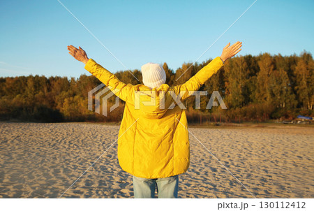 Happy woman on beach, enjoying amazing landscape, warm weather standing on sea coast Happy woman on beach, enjoying amazing landscape, warm weather standing on sea coast 130112412