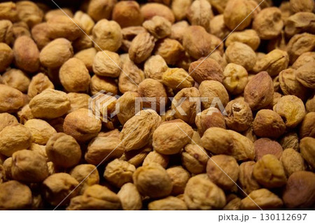 A CloseUp Look at a Vibrant, Colorful Display of Various Dried Nuts at a Market Stall 130112697