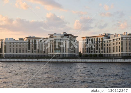 Stunning and Modern Waterfront Buildings Silhouetted Against a Beautiful Sunset Sky Stunning and Modern Waterfront Buildings Silhouetted Against a Beautiful Sunset Sky 130112847