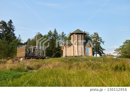 A Scenic Wooden Chapel Nestled and Surrounded by Nature in a Peaceful, Tranquil Landscape 130112958