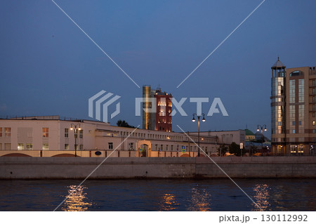 Enjoy the serene night view of the riverside architecture and stunning city lights 130112992