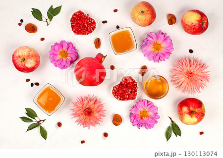 Autumn banner with honey, apples, pomegranates, flowers, dried fruits on marble background, composition for Jewish holiday Rosh Hashanah, autumn greeting and thanksgiving concept, 130113074