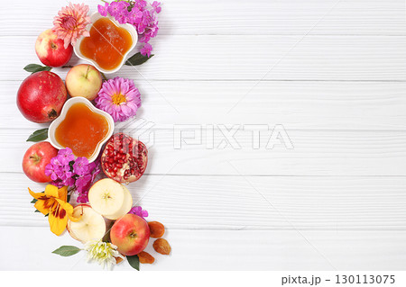 Apples, honey,pomegranate and dried apricots on a bright white background,The concept of the Jewish holiday Rosh Hashanah top view with a place for your text,Jewish New Year and Thanksgiving,selective Apples, honey,pomegranate and dried apricots on a bright white background,The concept of the Jewish holiday Rosh Hashanah top view with a place for your text,Jewish New Year and Thanksgiving,selective 130113075
