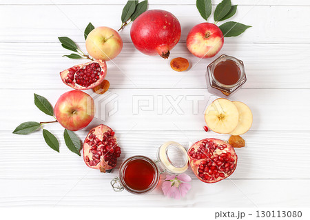 Autumn banner with honey, apples, pomegranates, flowers, dried fruits on a light background with place for text, composition for the Jewish holiday Rosh Hashan, Hello autumn and thanksgiving day 130113080