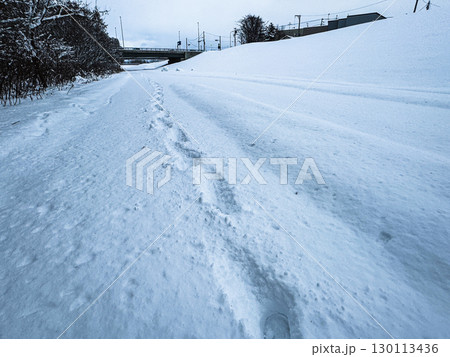 北海道・冬の河川敷と雪上の足跡 130113436