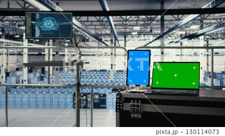 Green screen notebook and mockup tablet in industrial data center using artificial intelligence technology. Deep learning tech on isolated screen device and chroma key laptop in server room Green screen notebook and mockup tablet in industrial data center using artificial intelligence technology. Deep learning tech on isolated screen device and chroma key laptop in server room 130114073