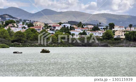 Breathtaking Scenic Lakeside Views Featuring Charming Houses and Majestic Mountains 130115939