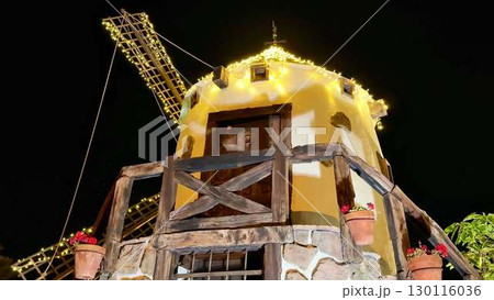 Stunning and Charming Night View of a Beautifully Decorated Windmill Adorned with Twinkling Lights Stunning and Charming Night View of a Beautifully Decorated Windmill Adorned with Twinkling Lights 130116036