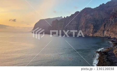 The breathtaking scenic coastal cliffs appear mesmerizing at sunset above the calm waters The breathtaking scenic coastal cliffs appear mesmerizing at sunset above the calm waters 130116038