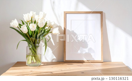 A spring floral arrangement of pink roses in a vase decorates a living room window A spring floral arrangement of pink roses in a vase decorates a living room window 130116321