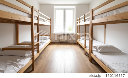 Luxurious hotel bedroom interior with a comfortable bed, elegant furniture, and a large window Luxurious hotel bedroom interior with a comfortable bed, elegant furniture, and a large window 130116337