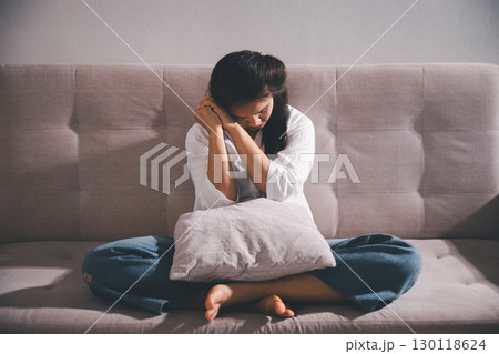 Sorrowful woman sat alone, overwhelmed by emotion, her sad and unhappy expression revealing deep despair, stress and distress left feeling depressed. sorrowful sad, despair alone, depressed stress Sorrowful woman sat alone, overwhelmed by emotion, her sad and unhappy expression revealing deep despair, stress and distress left feeling depressed. sorrowful sad, despair alone, depressed stress 130118624